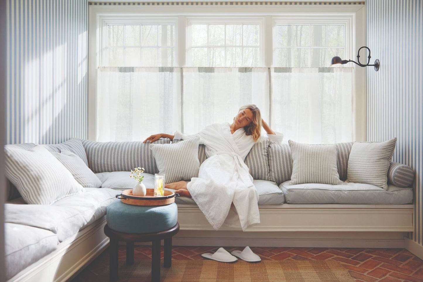 Woman in a white robe relaxing after a spa treatment in Hampton Bays, enjoying post massage relaxation.